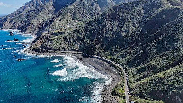Playa de Benijo aerial view with black sand, parking access, and surf
