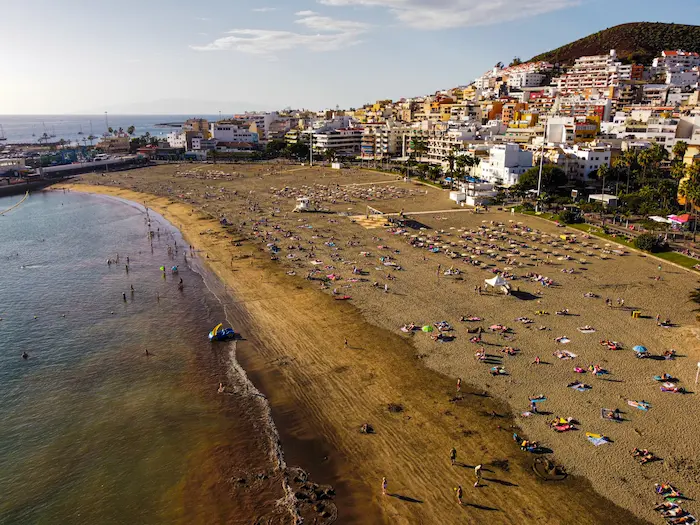 Los Cristianos Beach with golden sand and the town in the background