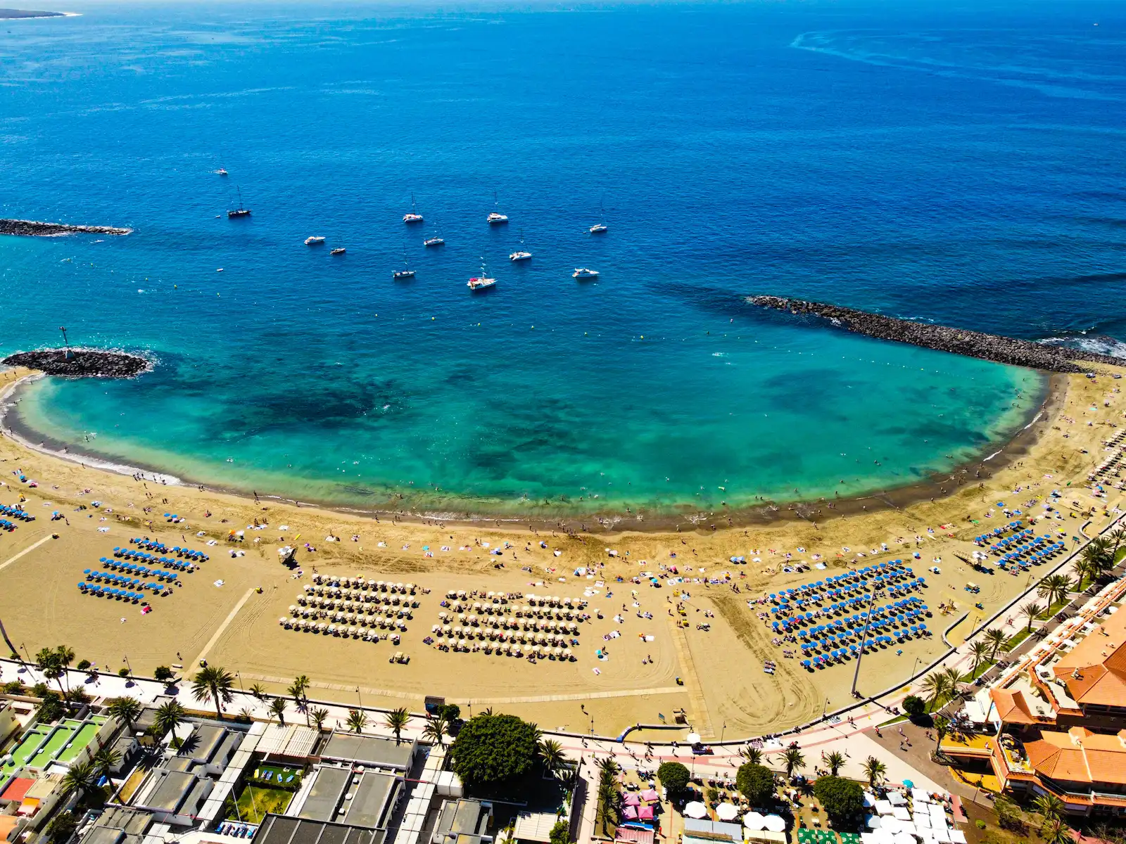 Calm turquoise water and sunbeds on Los Cristianos Beach