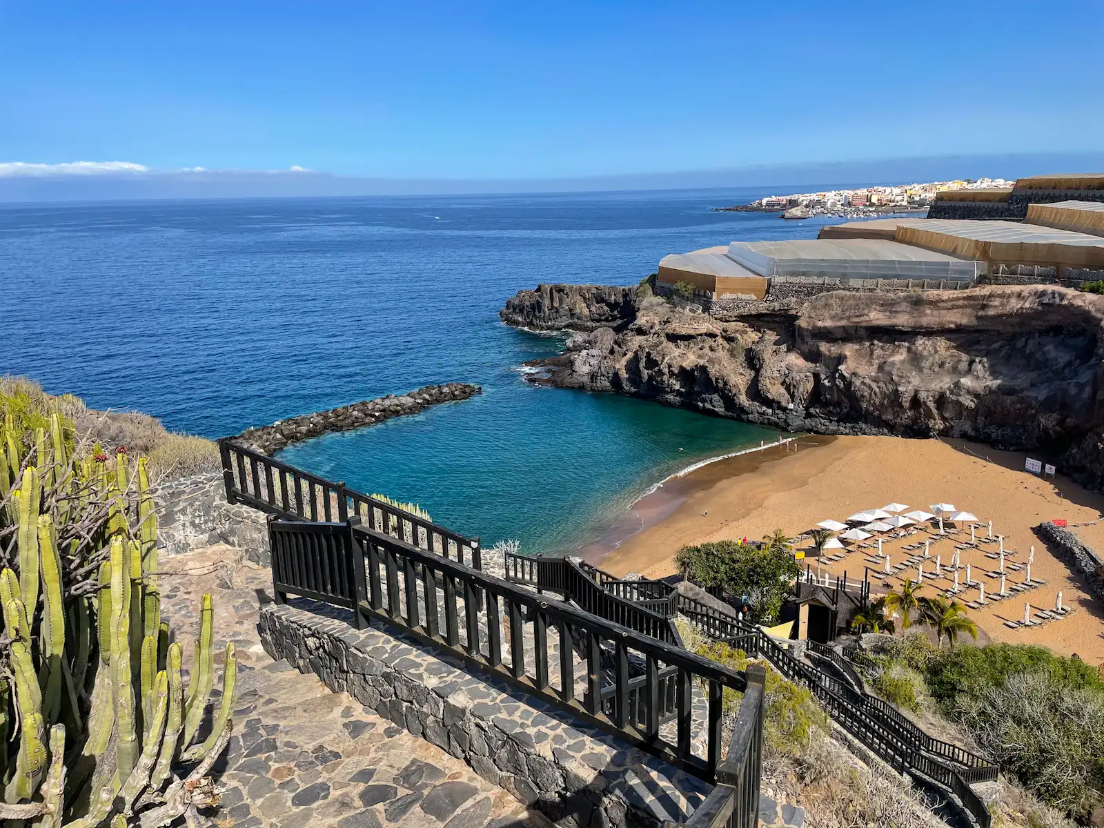 Staircase leading down to Playa Abama with a view of the ocean and cliffs