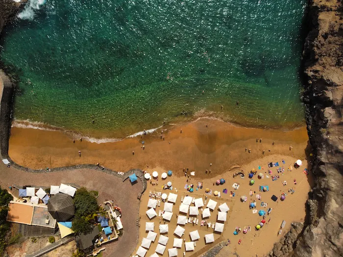 Overhead view of sunbeds and beachgoers at Playa Abama Tenerife