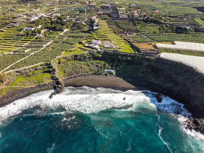 Aerial view of Playa de los Patos – a wide natural black sand beach