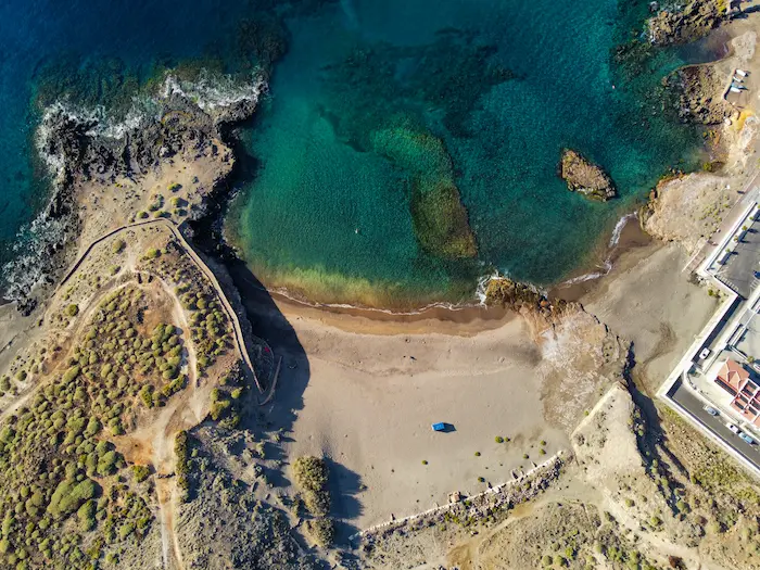 Aerial view of Abades Beach Tenerife with turquoise water and natural volcanic rock.