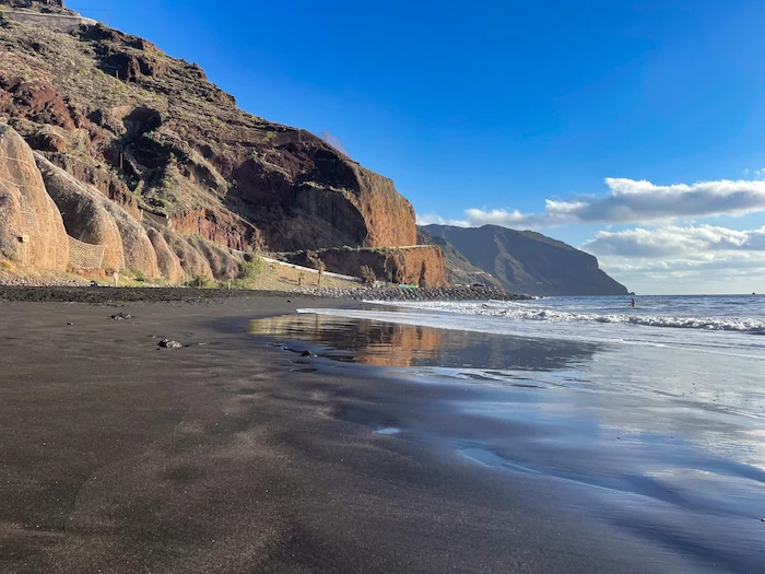 Playa de Las Gaviotas wide view with volcanic cliffs