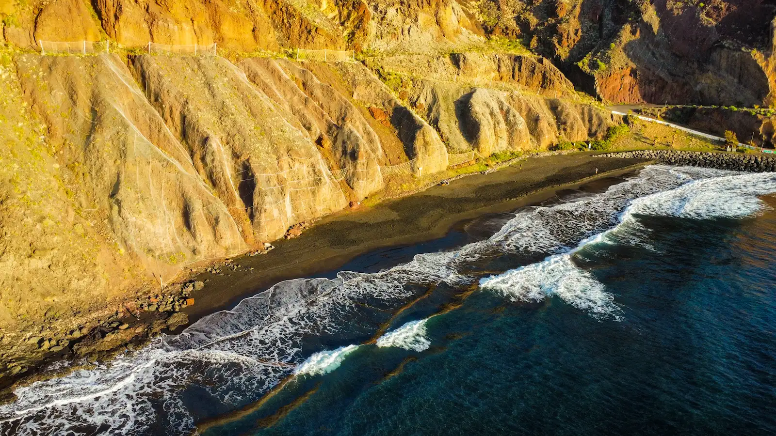 Waves rolling onto the black sand at Playa de Las Gaviotas