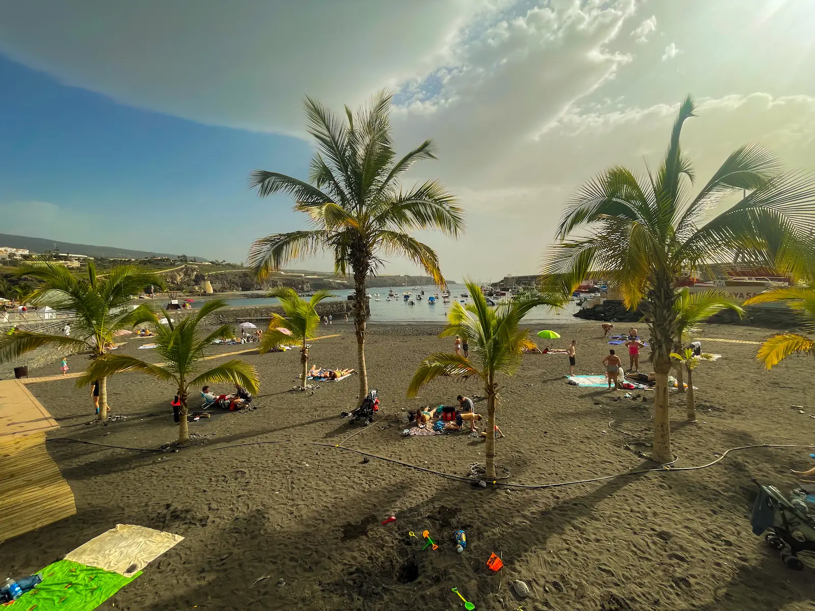 Black sand beach at Playa San Juan Tenerife with palm trees