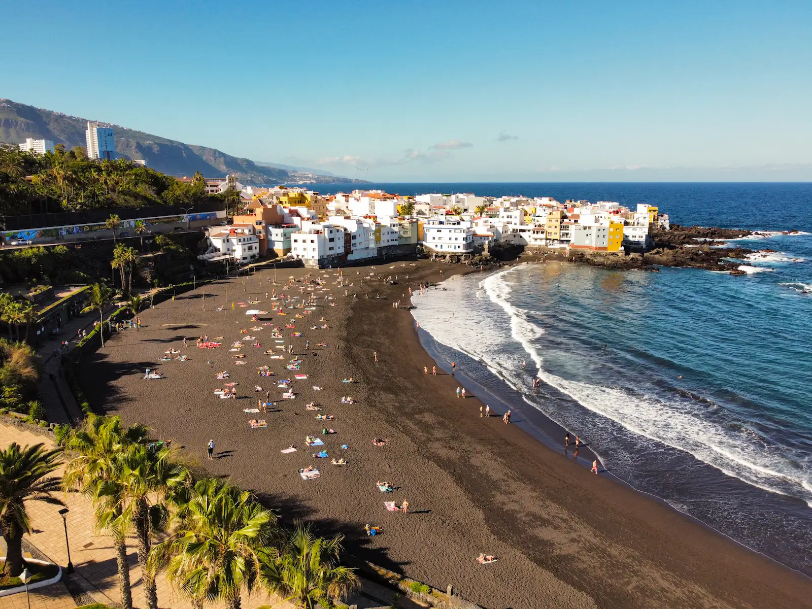 Playa de San Telmo next to the coastal promenade and town buildings in Puerto de la Cruz.
