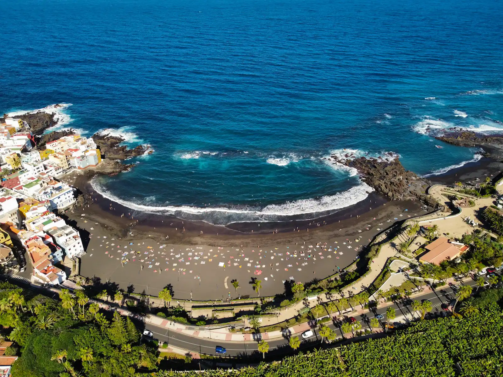 Playa Jardín in Puerto de la Cruz seen from above, with black volcanic sand and calm waters.