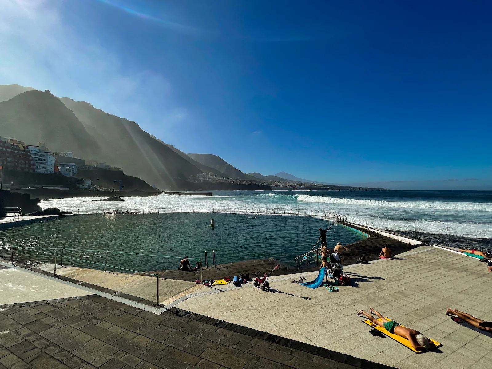 People relaxing next to the Punta del Hidalgo natural pool