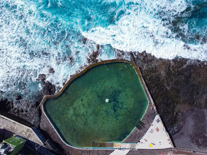 Punta del Hidalgo natural pool from above with turquoise water and waves