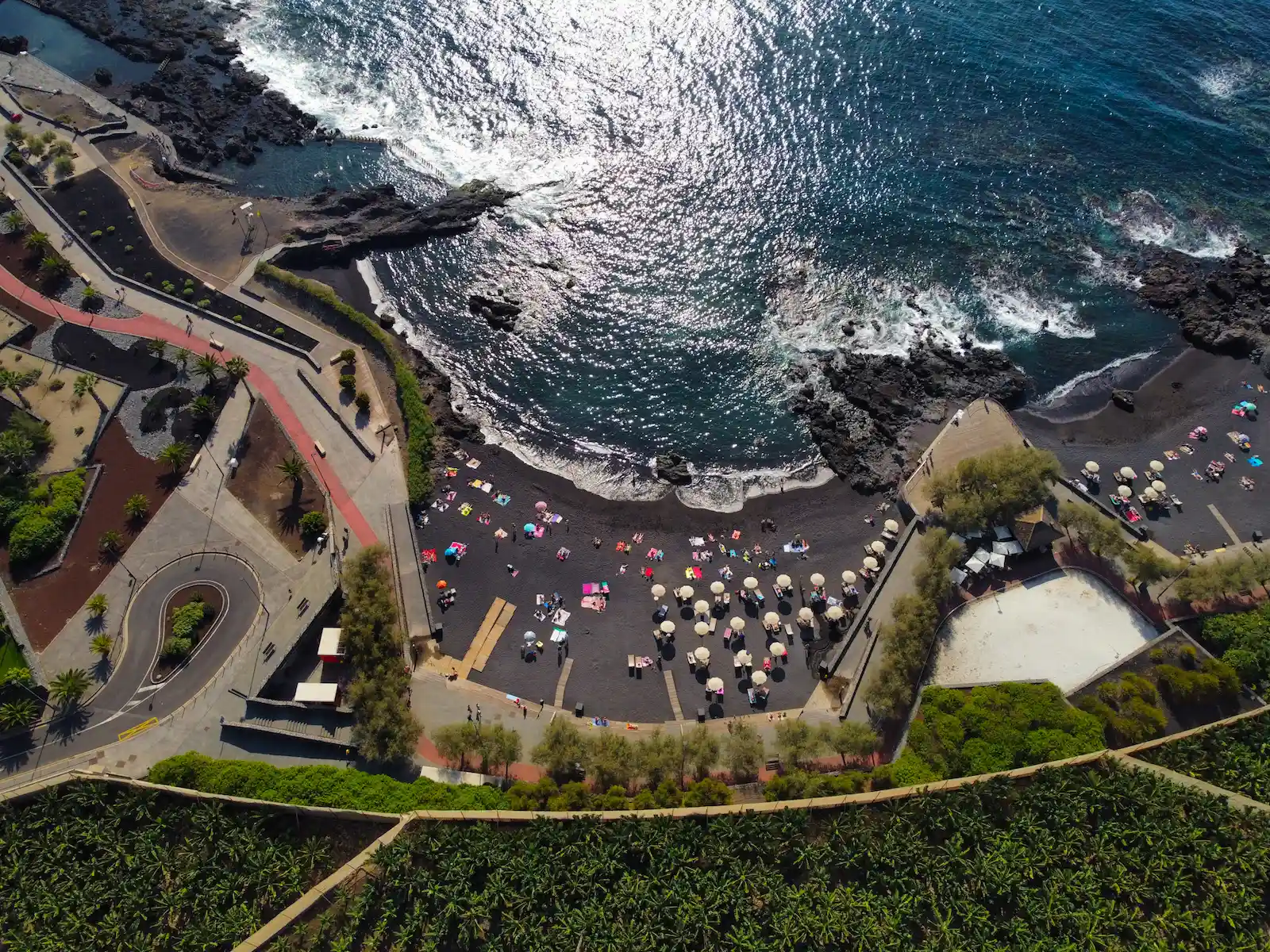 Aerial view of Playa de Alcalá with sunbeds and volcanic coastline in Tenerife