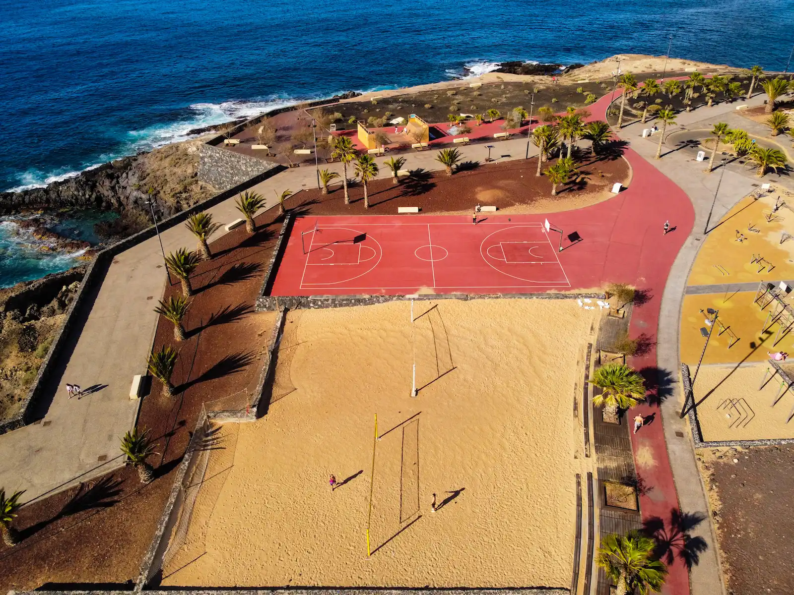 Aerial view of sports courts by the ocean along the coastal walk in Alcalá Tenerife