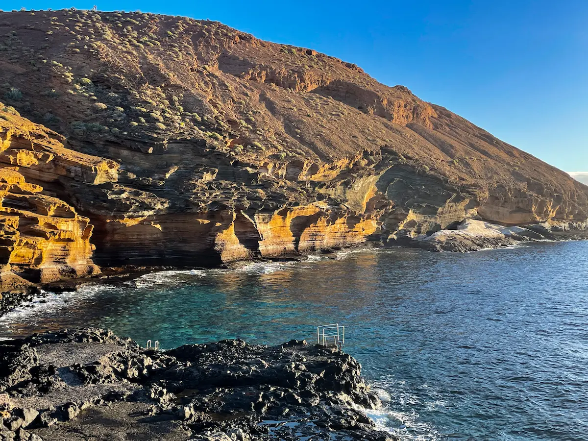 Sea ladder and volcanic cliff at Montaña Amarilla Tenerife