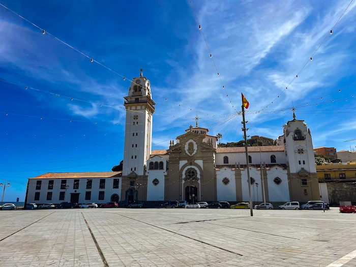 Wide front view of the Basilica of Candelaria under a clear sky