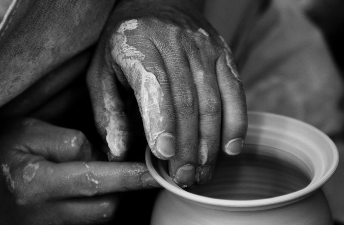 Potter’s hands shaping clay at Casa las Miquelas in Candelaria