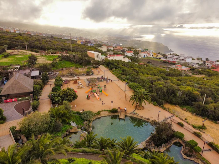 Aerial view of El Montillo Park in Tenerife with paths, pond, and playgrounds