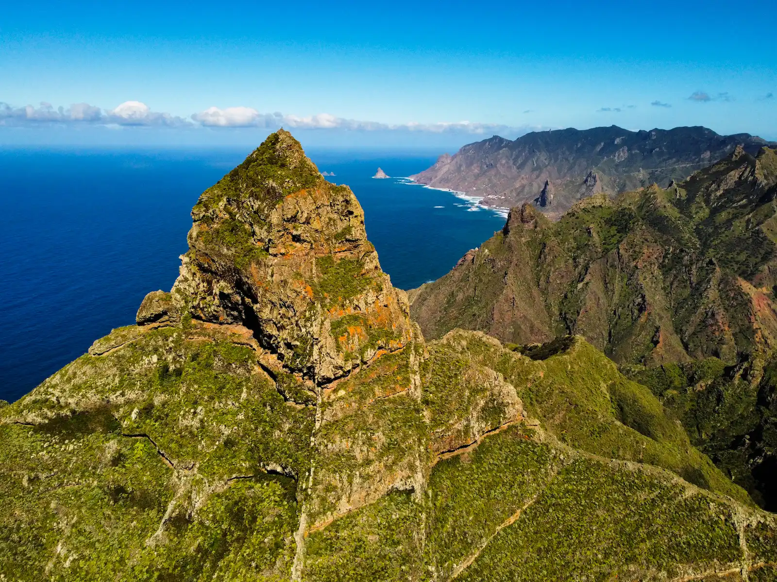 Roque de Taborno rising above the Anaga cliffs with the ocean in the background