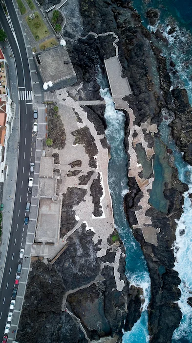Aerial view of El Caletón natural pools in Garachico, Tenerife, surrounded by volcanic rocks and walkways