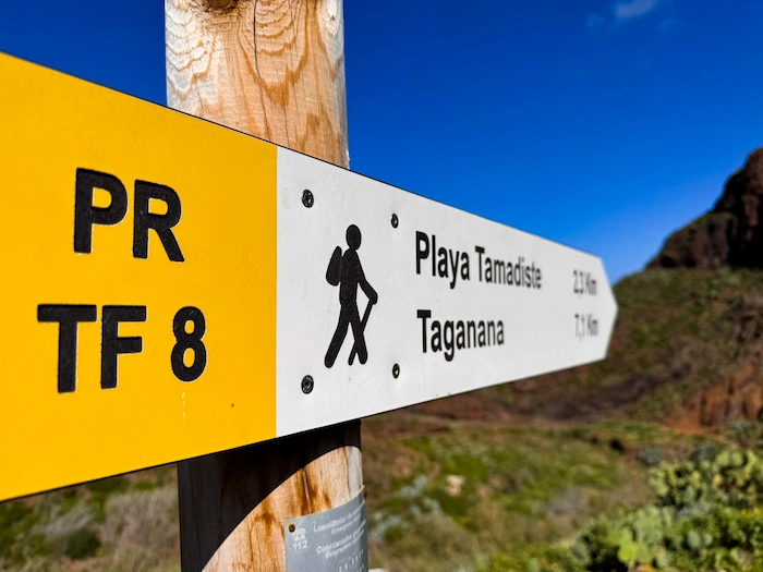 Yellow trail sign pointing to Playa Tamadite and Taganana