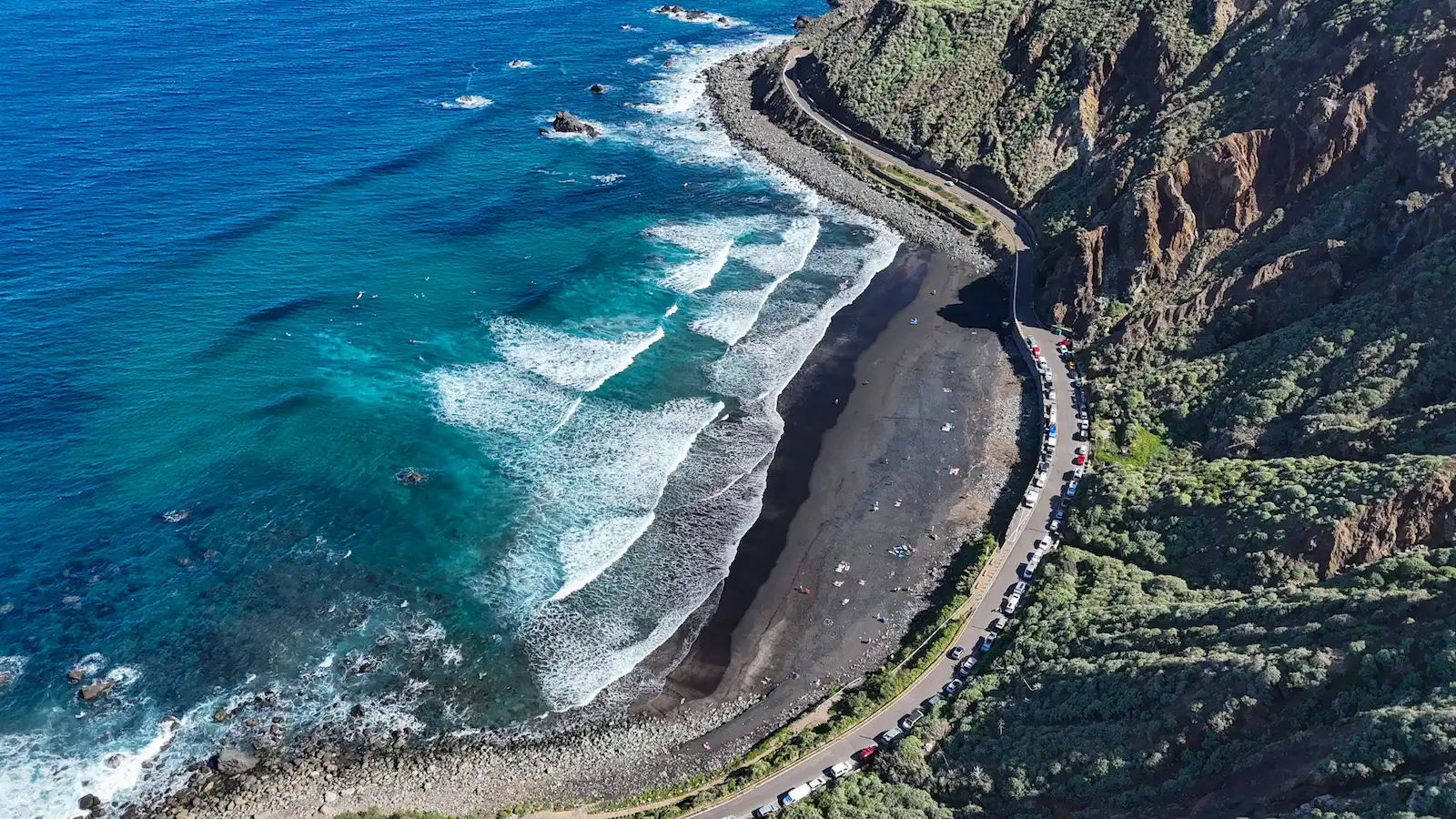 Playa de Benijo aerial view with black sand, parking access, and surf