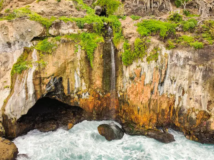Rocky cave and waterfall beneath Casa Hamilton by the Atlantic Ocean