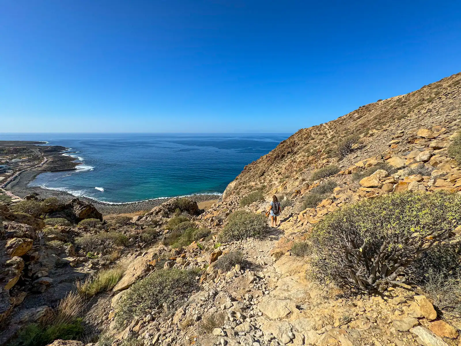 Narrow rocky trail on a cliffside above the ocean near Palm-Mar