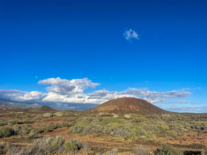 Volcanic hill near Los Cristianos with clouds above the trail