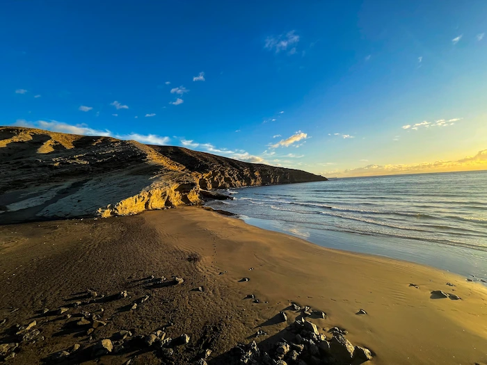 Coastal cliffs and calm ocean at sunset near La Tejita, Tenerife