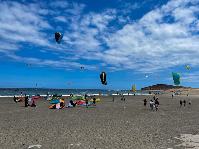 Colorful kitesurfing sails flying above El Médano beach in Tenerife