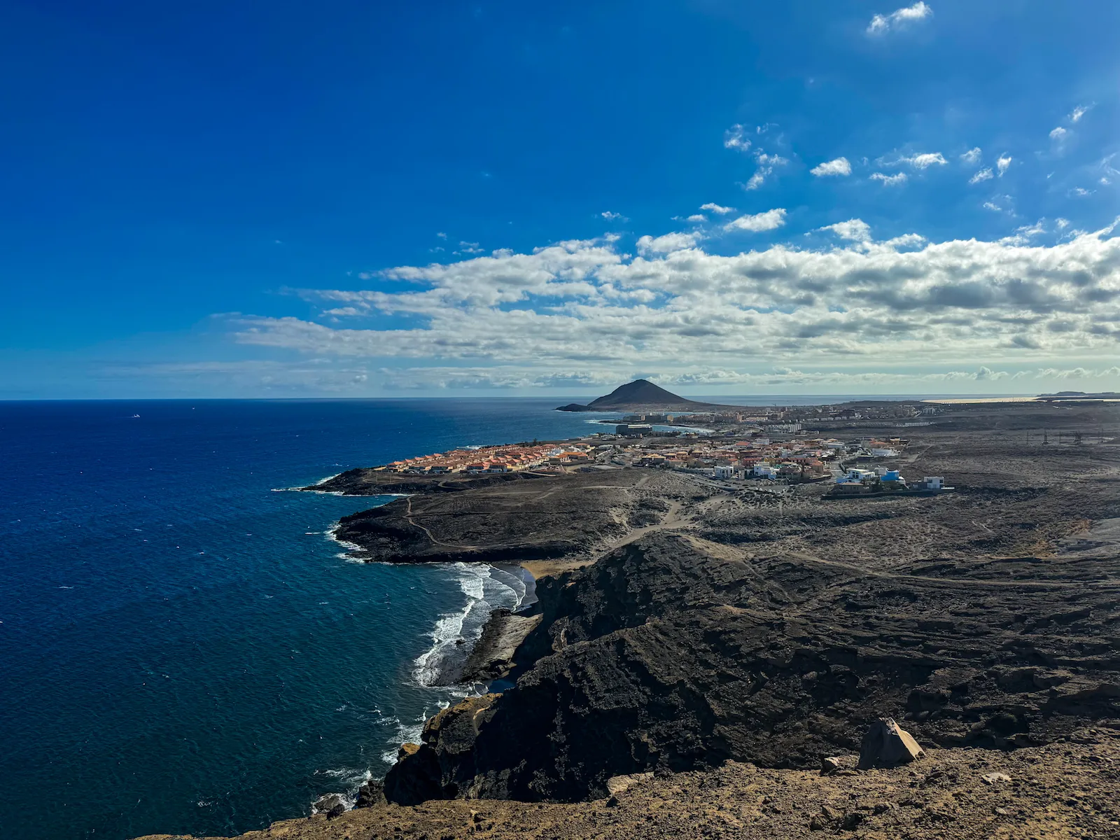 Aerial coastal view of El Médano with Montaña Roja in the distance