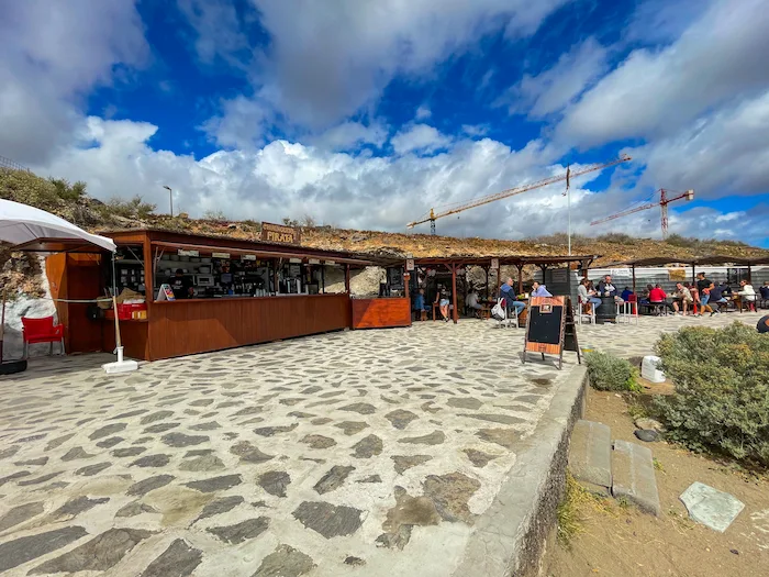 Beach bar at Playa de La Tejita with stone path and blue sky
