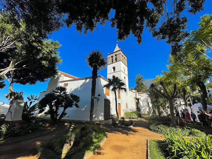 Iglesia de San Marcos with palm trees and volcanic garden