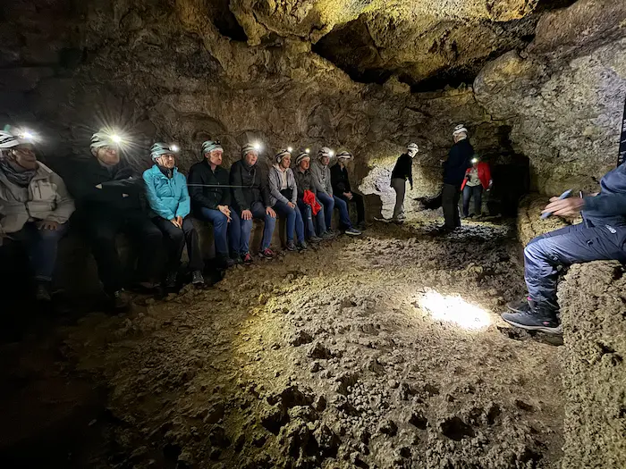 Tour group exploring inside the Cueva del Viento lava tube