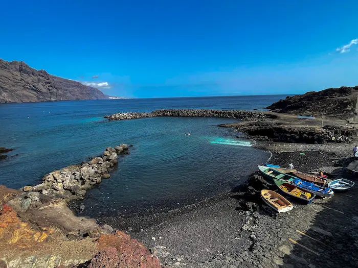 Small bay with clear water and fishing boats at Playa de Punta de Teno, Tenerife