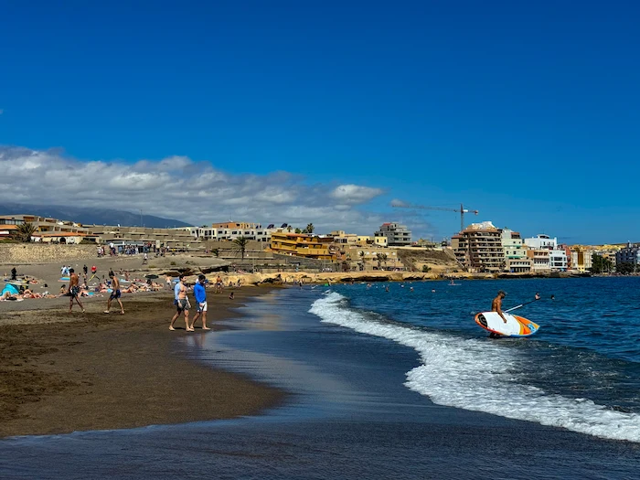 SUP Surfer entering the water on the beach in El Médano