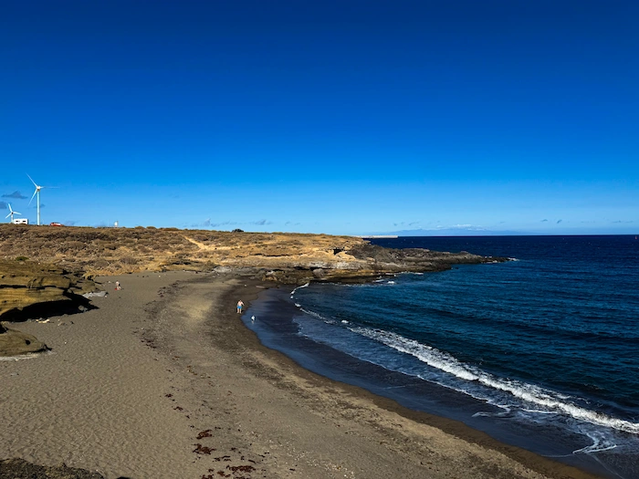 Playa Escondida nudist beach in Tenerife with volcanic sand and ocean view